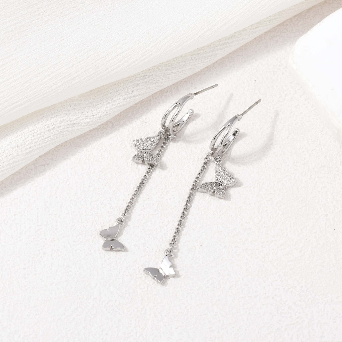 Silver dangling butterfly earrings – alternate angle