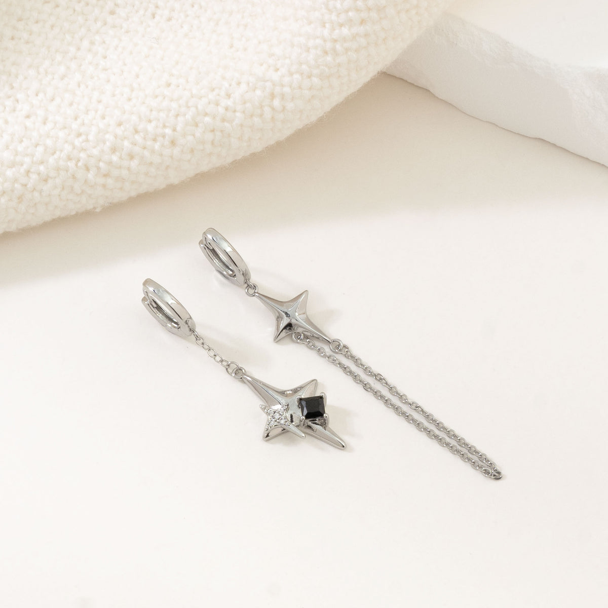 Silver asymmetric 4-point star earrings – alternate angle