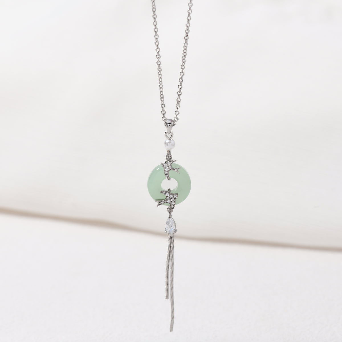 Silver imitation jade bird necklace – on white background