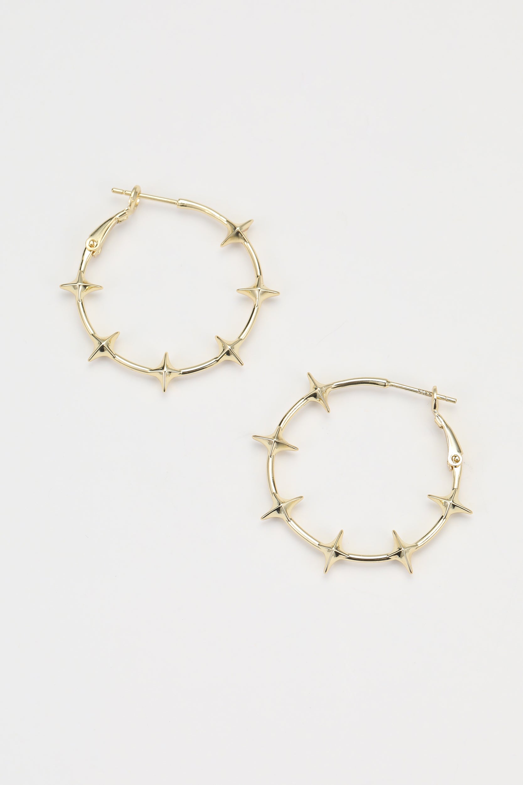 Gold flare earrings – on white background