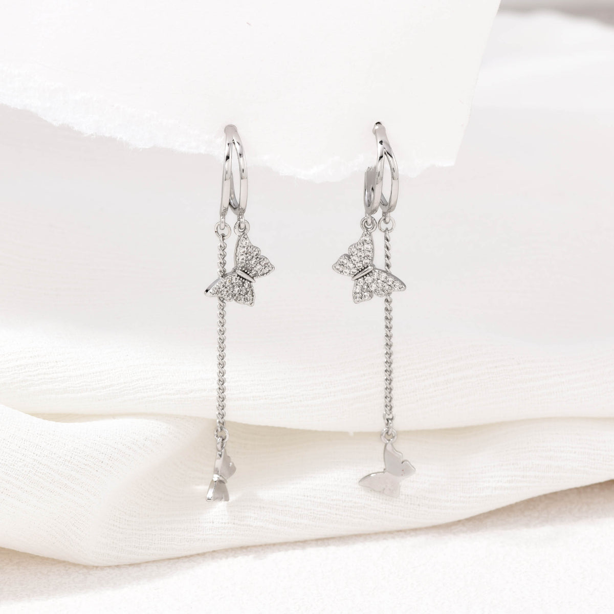 Silver dangling butterfly earrings – alternate angle