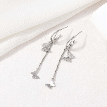 Silver dangling butterfly earrings – alternate angle