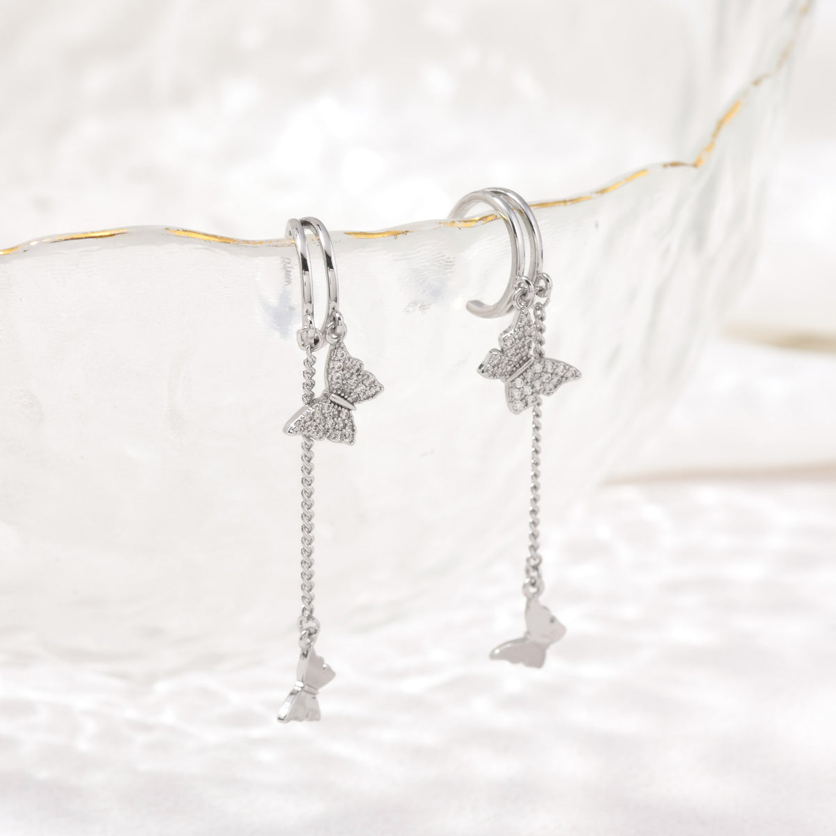 Silver dangling butterfly earrings – detail view
