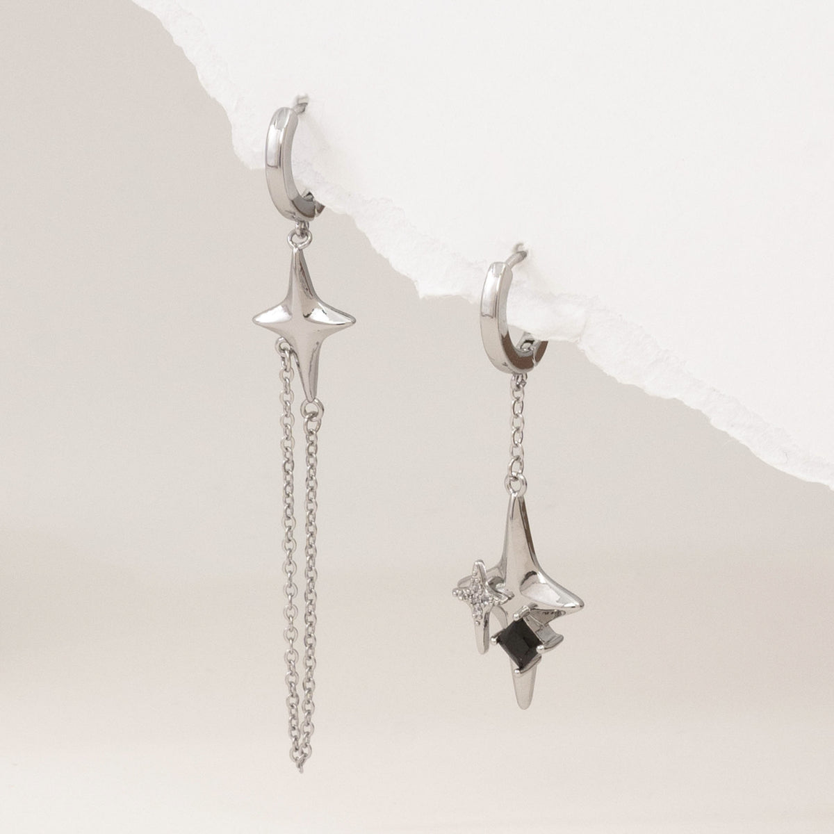 Silver asymmetric 4-point star earrings – alternate angle