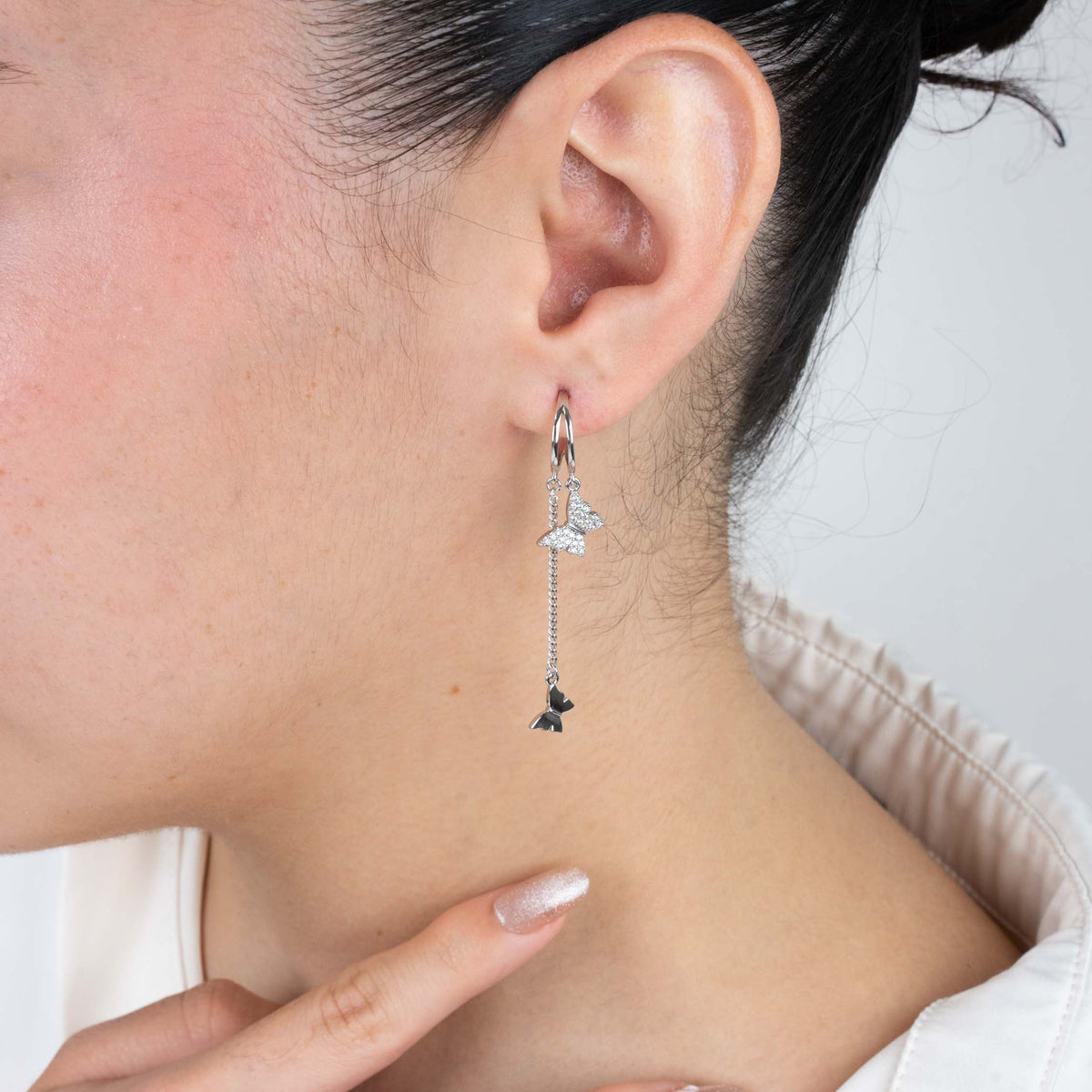 Silver dangling butterfly earrings – alternate angle