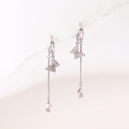 Silver dangling butterfly earrings – on white background